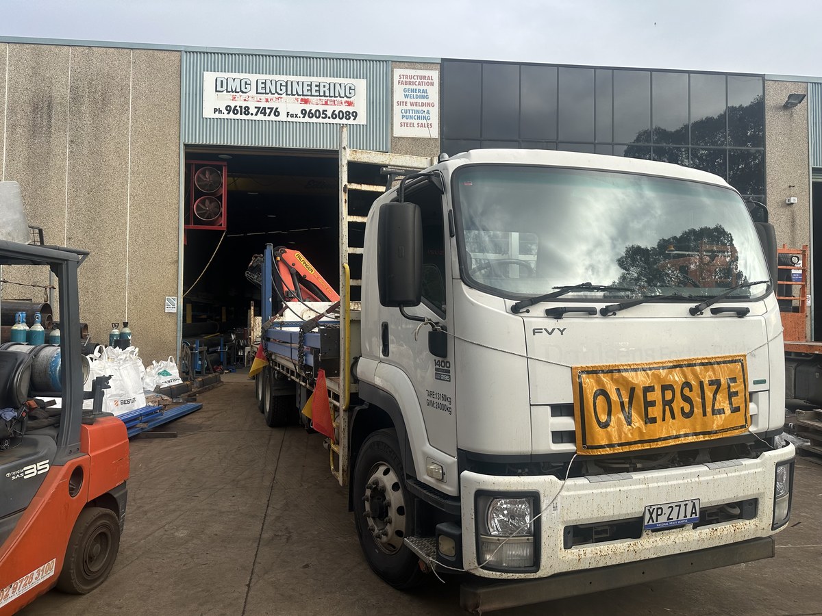 RKL Transport crane truck loading steel at a Sydney fabrication workshop