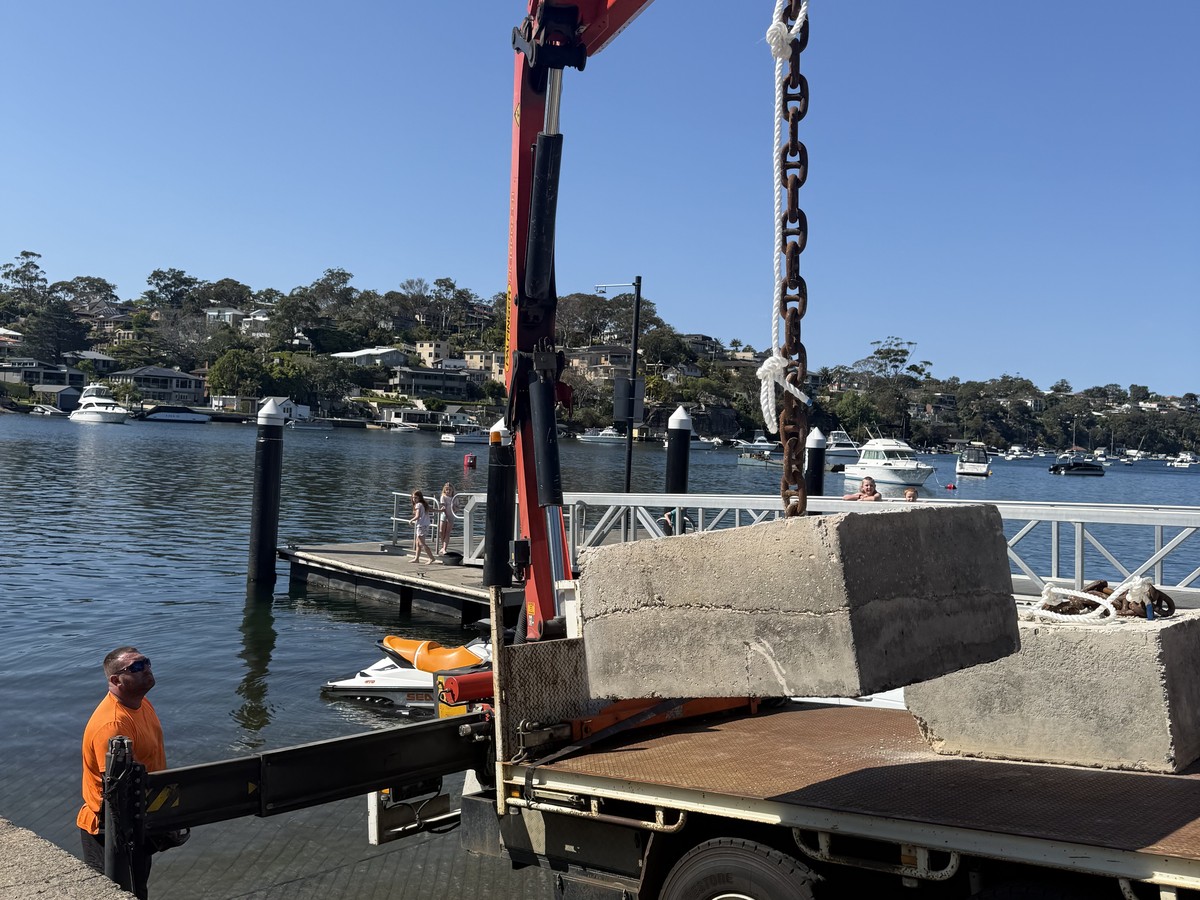 Crane truck lift of concrete blocks at a Sydney waterfront site